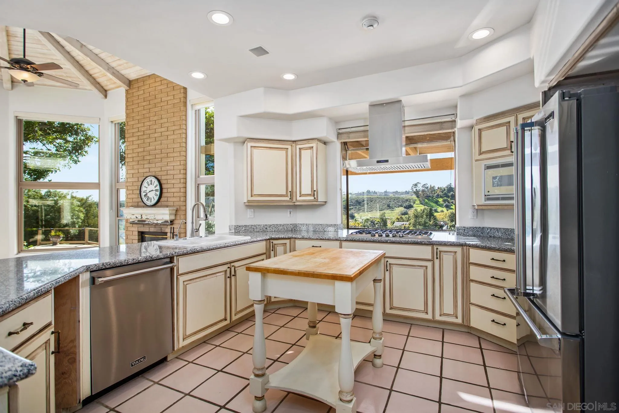 4489 Fallsbrae Road Fallbrook, CA 92028 - Photo 11 of 46 a kitchen with a sink and chairs