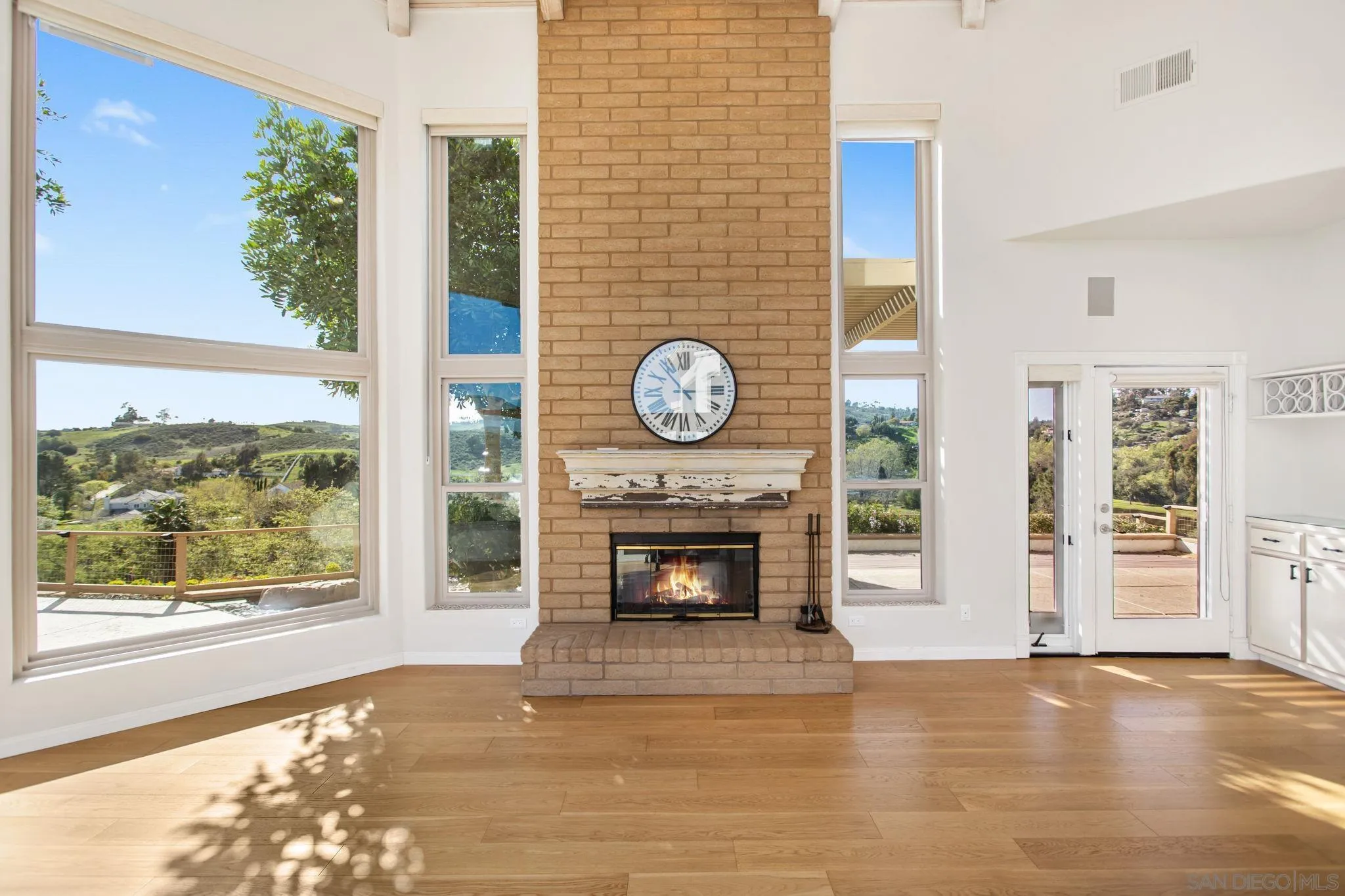 4489 Fallsbrae Road Fallbrook, CA 92028 - Photo 14 of 46 a view of an empty room with wooden floor fireplace and a window
