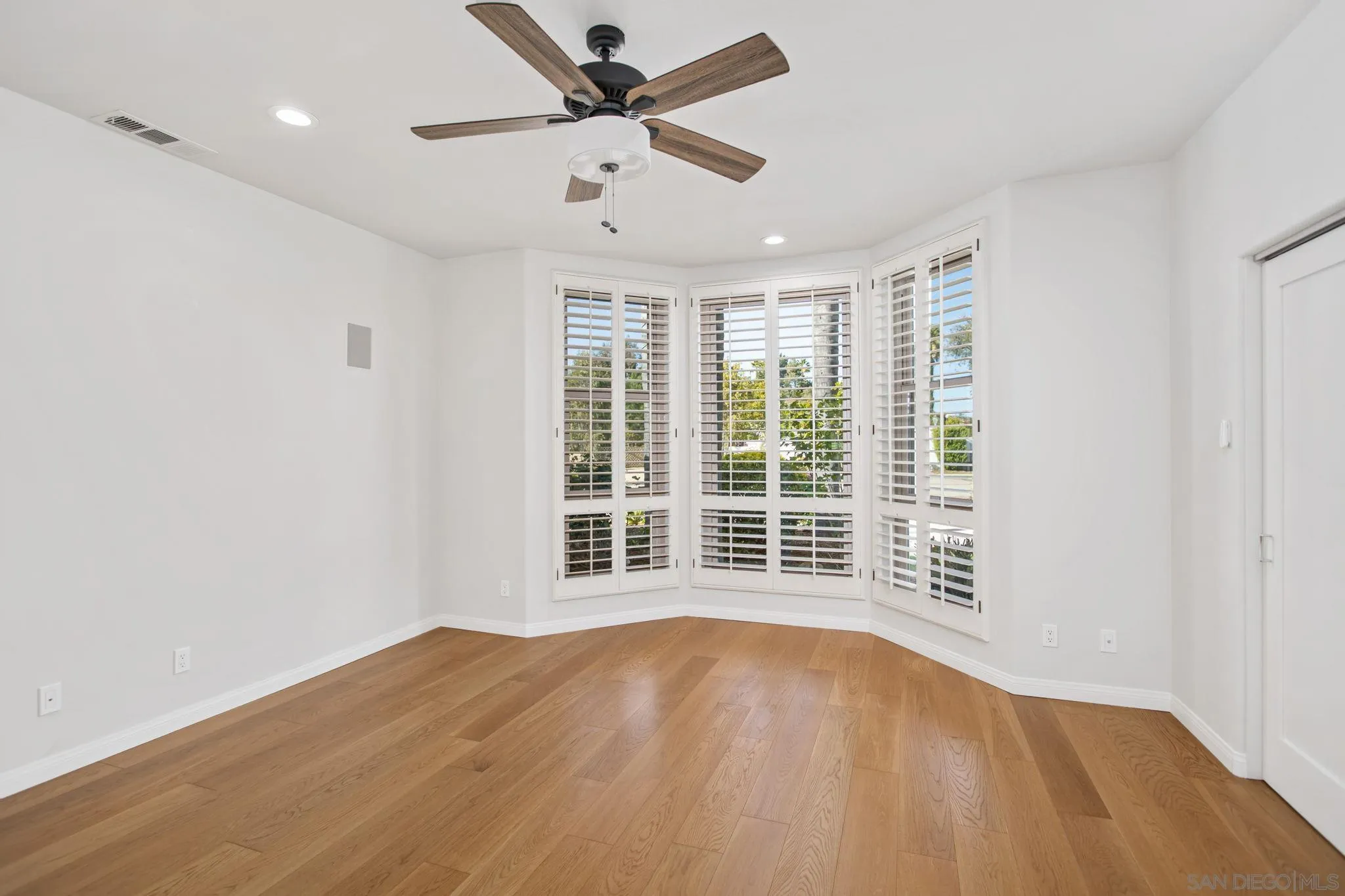 4489 Fallsbrae Road Fallbrook, CA 92028 - Photo 16 of 46 an empty room with wooden floor and windows