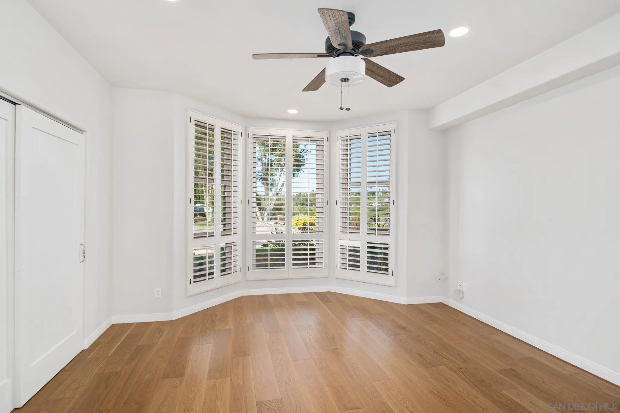 4489 Fallsbrae Road Fallbrook, CA 92028 - Photo 18 of 46 an empty room with wooden floor and windows