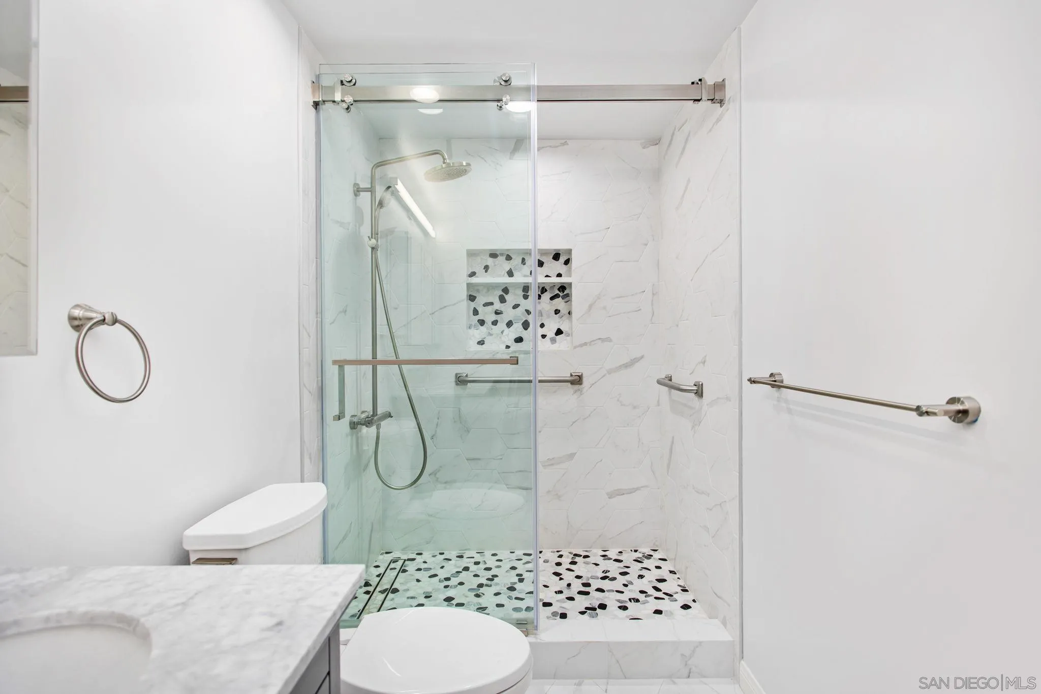 4489 Fallsbrae Road Fallbrook, CA 92028 - Photo 20 of 46 a bathroom with a shower toilet and a sink