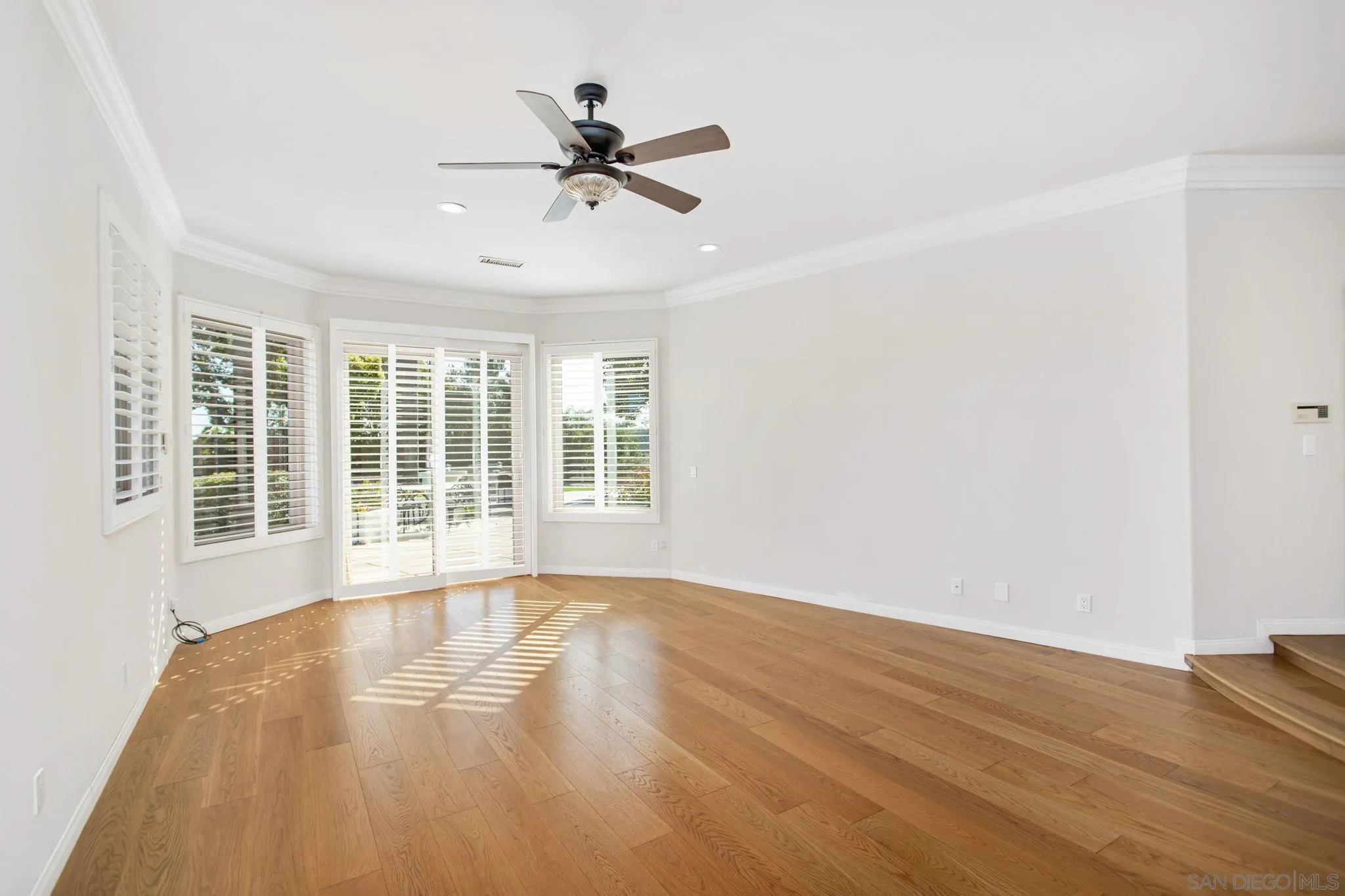 4489 Fallsbrae Road Fallbrook, CA 92028 - Photo 21 of 46 a view of an empty room with a window and wooden floor