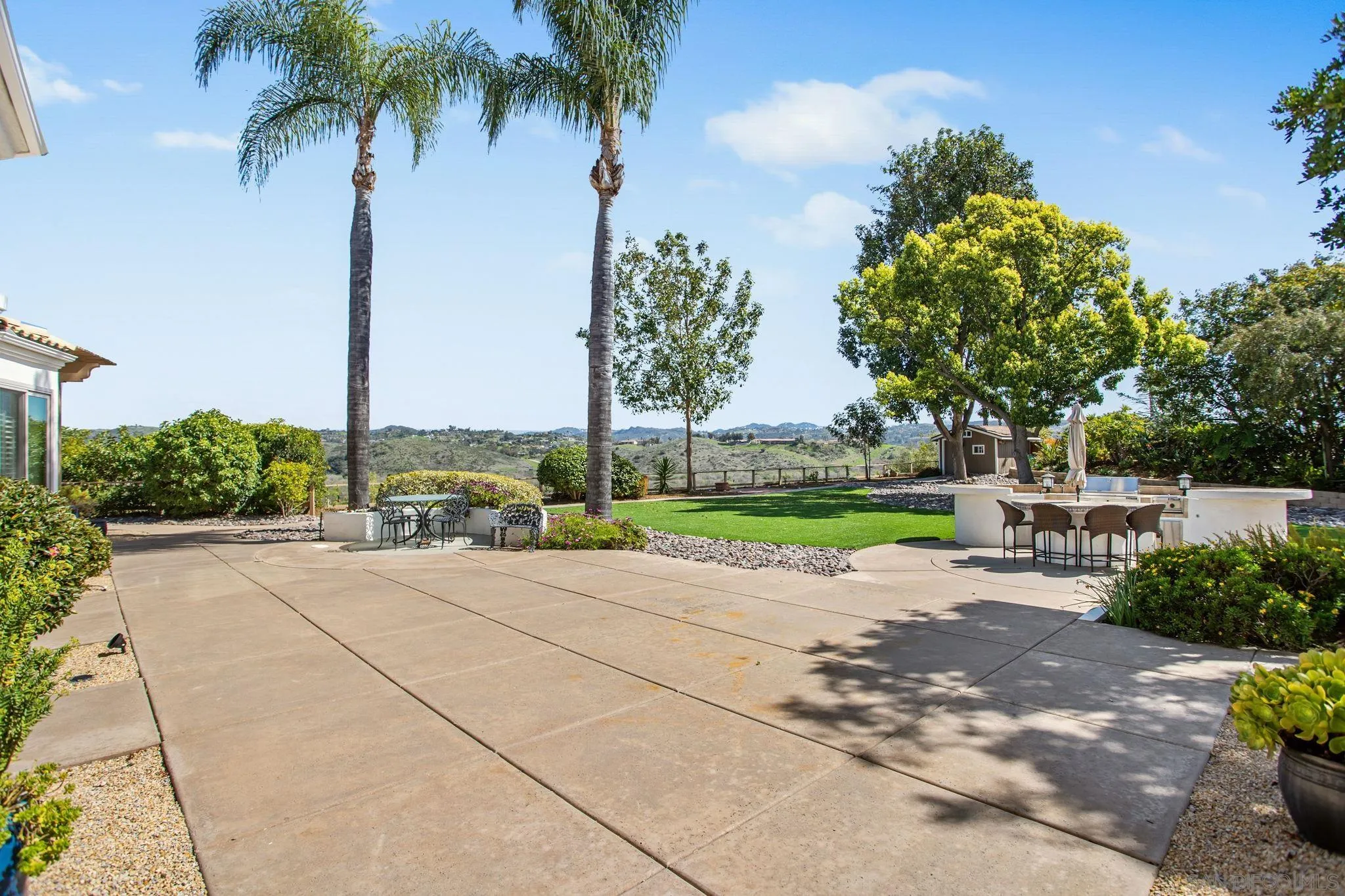 4489 Fallsbrae Road Fallbrook, CA 92028 - Photo 35 of 46 a row of palm trees and a yard with swimming pool