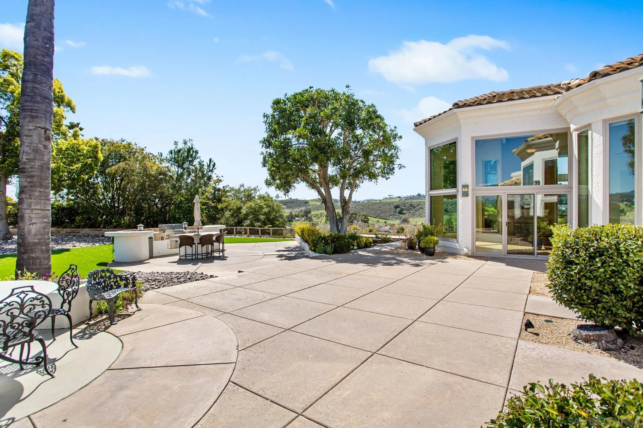 4489 Fallsbrae Road Fallbrook, CA 92028 - Photo 36 of 46 a view of a patio with dining table and chairs with a garden