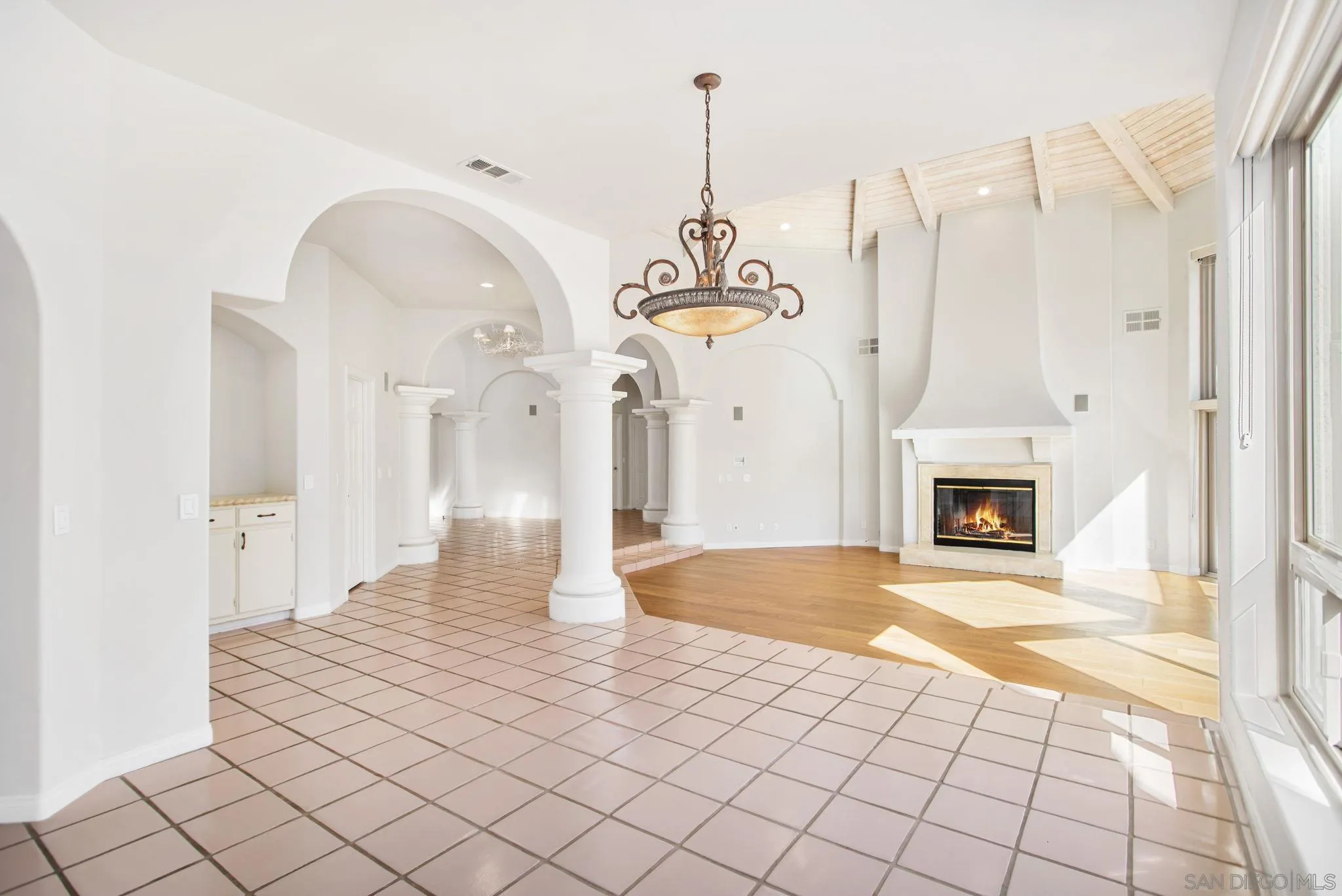 4489 Fallsbrae Road Fallbrook, CA 92028 - Photo 7 of 46 a view of a livingroom with a fireplace a chandelier and wooden floor