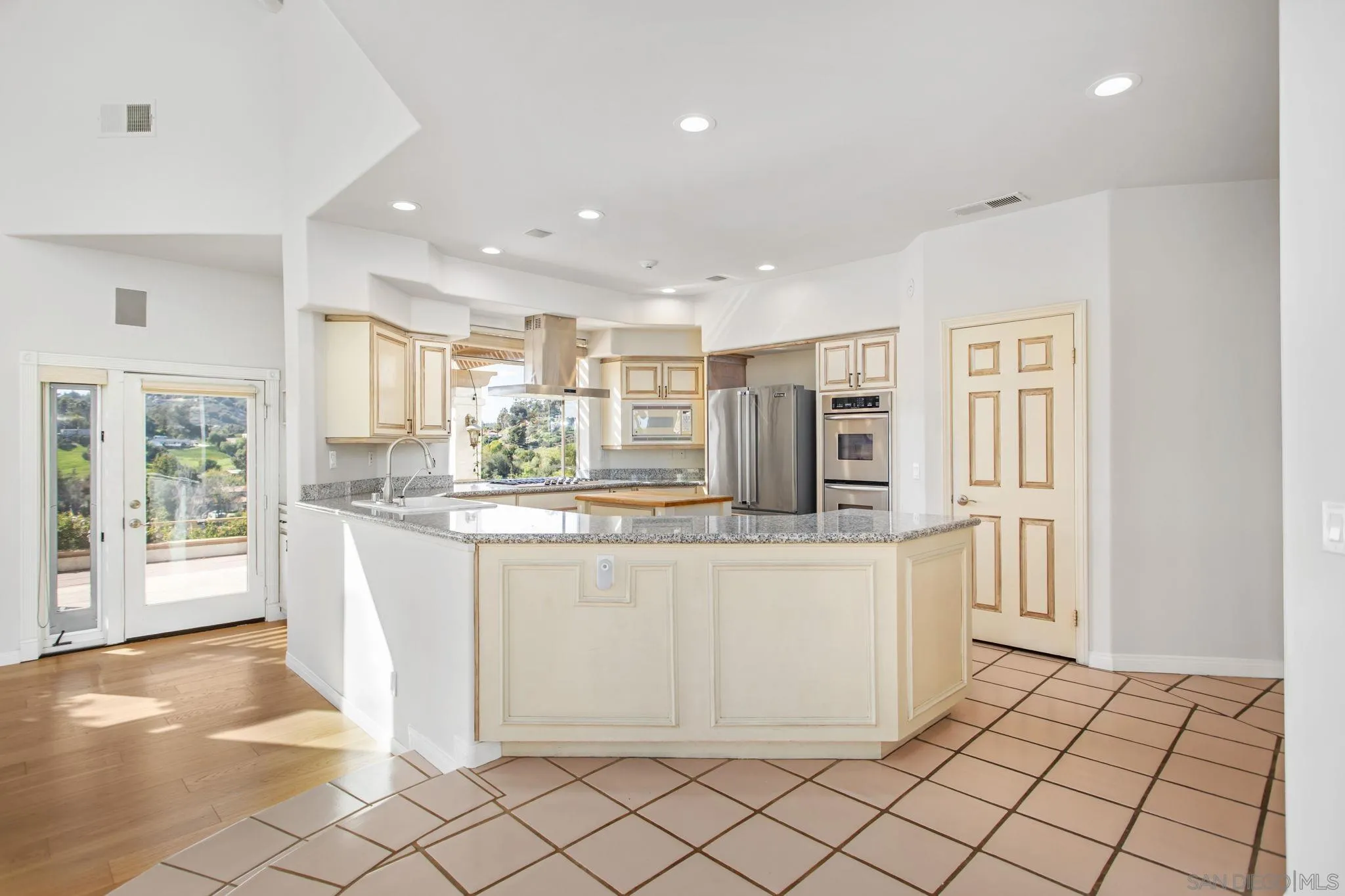 4489 Fallsbrae Road Fallbrook, CA 92028 - Photo 9 of 46 a kitchen with stainless steel appliances granite countertop a refrigerator and a stove top oven