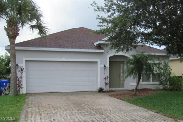 a front view of a house with a yard and garage