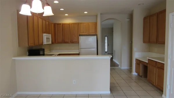 a kitchen with kitchen island granite countertop wooden cabinets and stainless steel appliances