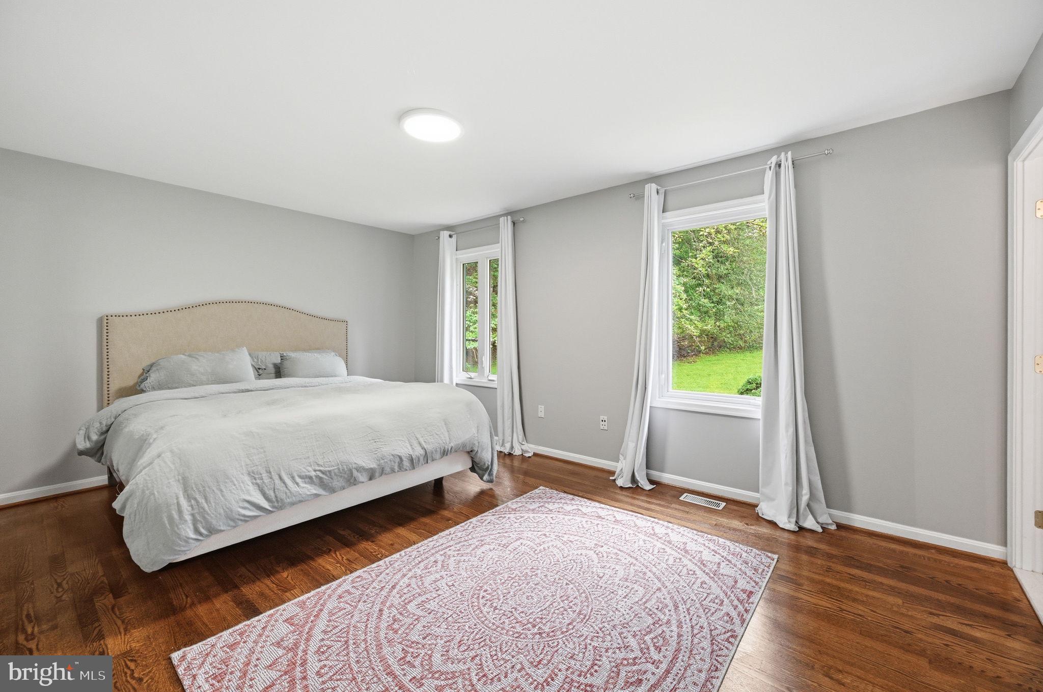 2506 Pinoak Lane Reston, VA 20191 - Photo 9 of 33 a bedroom with a bed and wooden floor