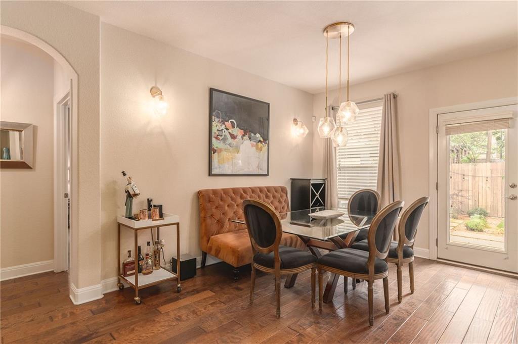 6708 Menchaca Road, Unit 14 Austin, TX 78745 - Photo 15 of 22 Dining area with wood-finish flooring and an arched doorway