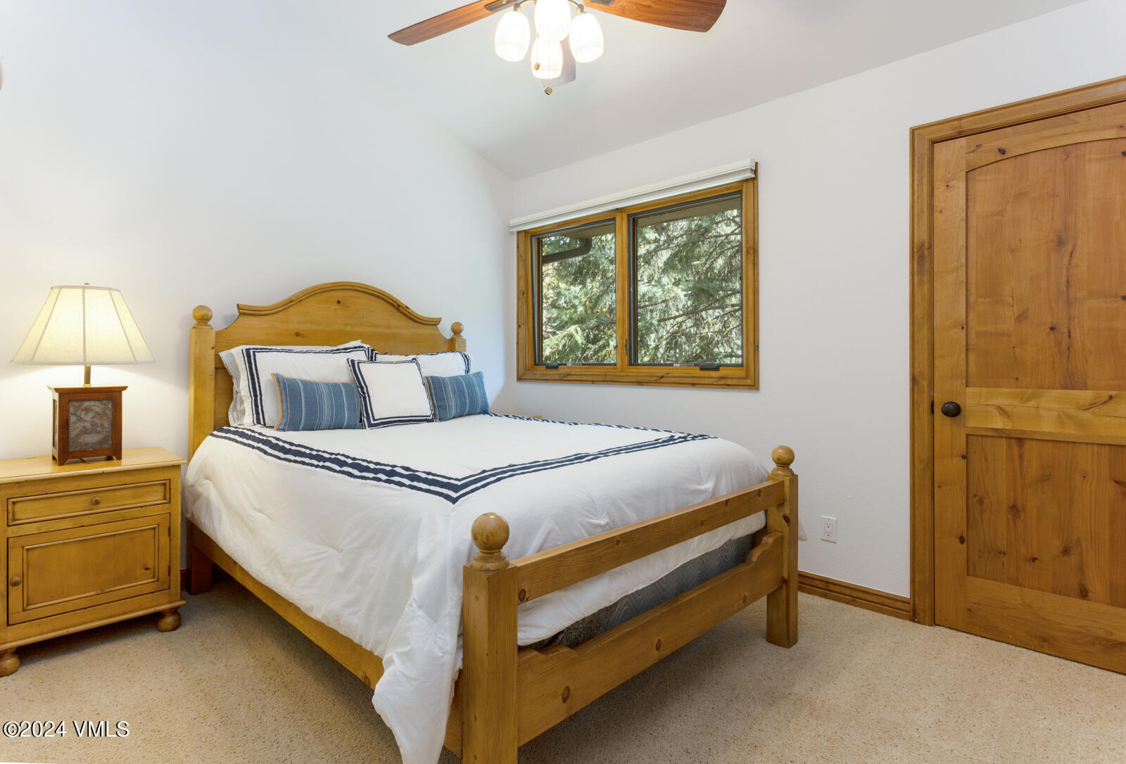 4552 Meadow Drive, Unit 24 Vail, CO 81657 - Photo 20 of 31 a bedroom with a bed and a chandelier
