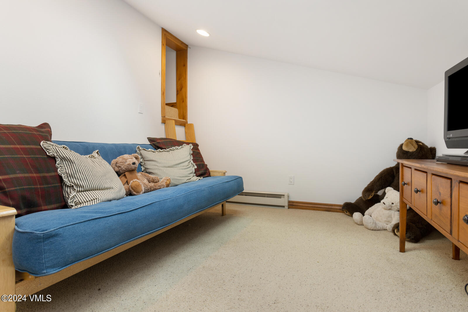 4552 Meadow Drive, Unit 24 Vail, CO 81657 - Photo 26 of 31 a living room with furniture and a flat screen tv