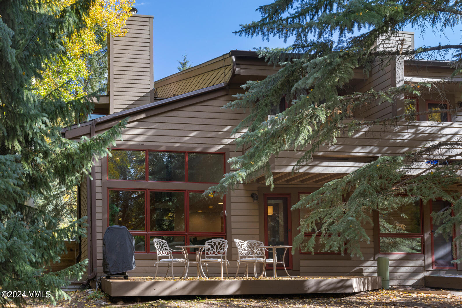 4552 Meadow Drive, Unit 24 Vail, CO 81657 - Photo 28 of 31 a view of a chairs and table in backyard