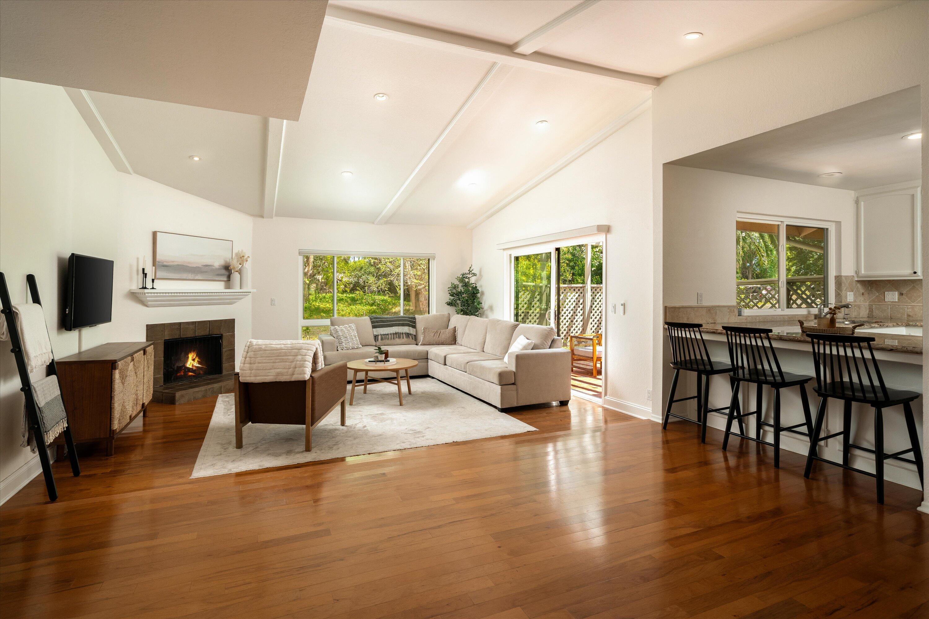 276 North La Cumbre Road Santa Barbara, CA 93110 - Photo 3 of 16 a living room with furniture a fireplace and a table