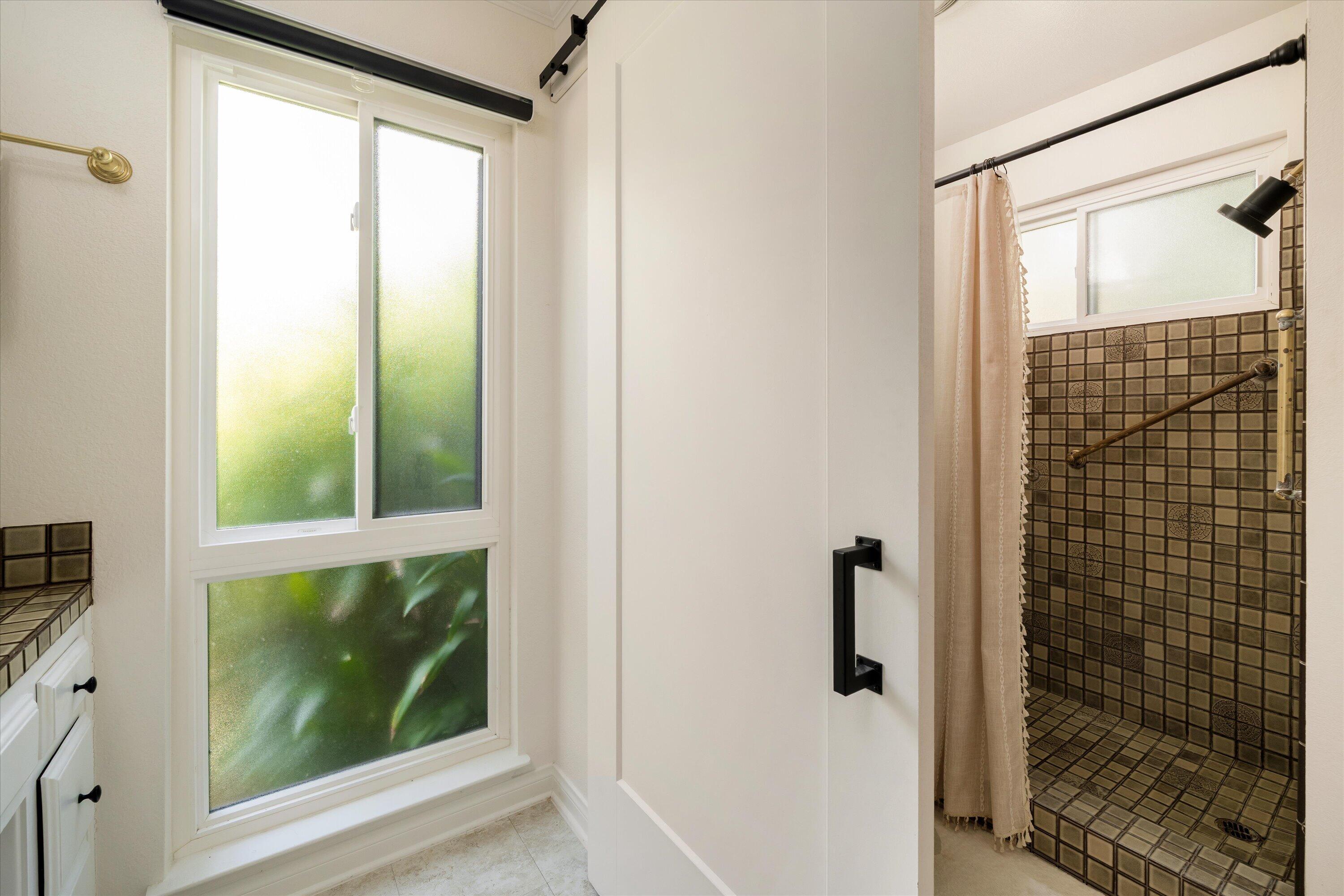 276 North La Cumbre Road Santa Barbara, CA 93110 - Photo 9 of 16 a bathroom with a glass shower door