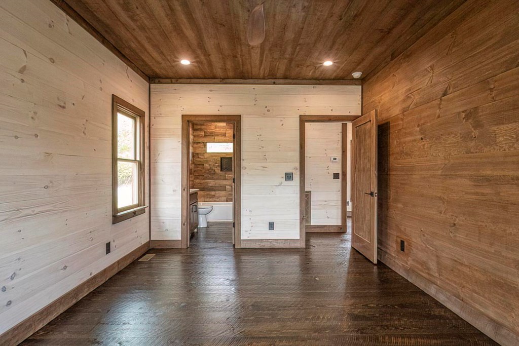 506 Pony Ghost Trail Blue Ridge, GA 30513 - Photo 17 of 62 an empty room with wooden floor and windows
