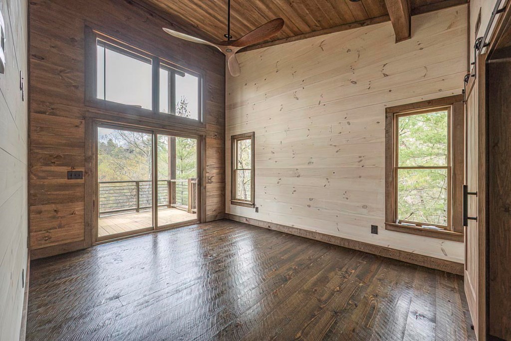 506 Pony Ghost Trail Blue Ridge, GA 30513 - Photo 31 of 62 an empty room with wooden floor and windows
