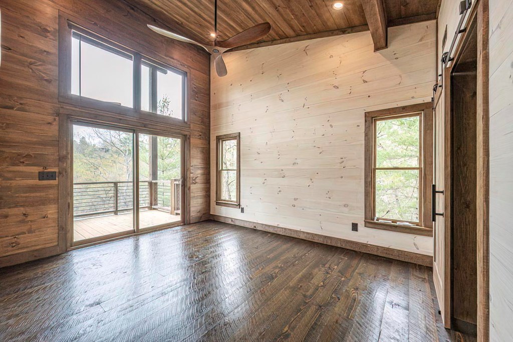 506 Pony Ghost Trail Blue Ridge, GA 30513 - Photo 32 of 62 an empty room with wooden floor and windows