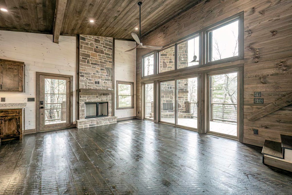 506 Pony Ghost Trail Blue Ridge, GA 30513 - Photo 4 of 62 a view of an empty room with wooden floor and a fireplace