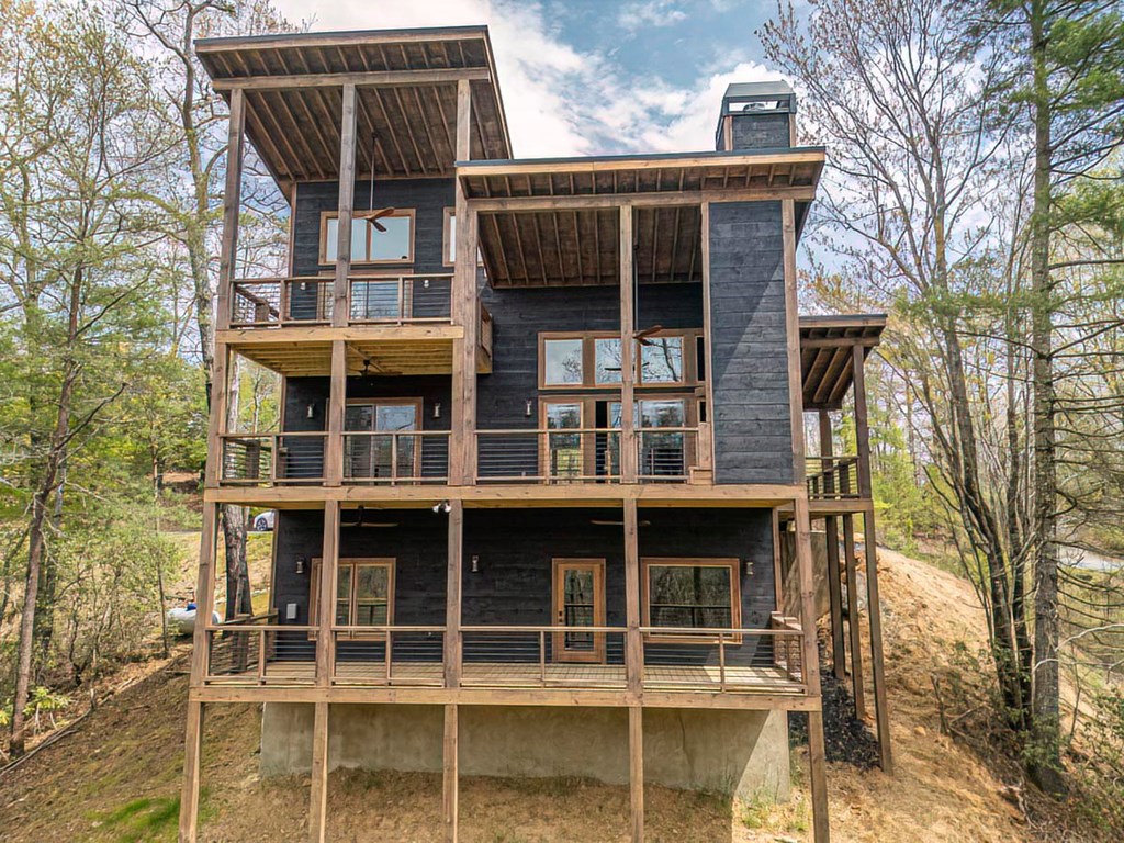 506 Pony Ghost Trail Blue Ridge, GA 30513 - Photo 45 of 62 a view of house with large windows and wooden fence