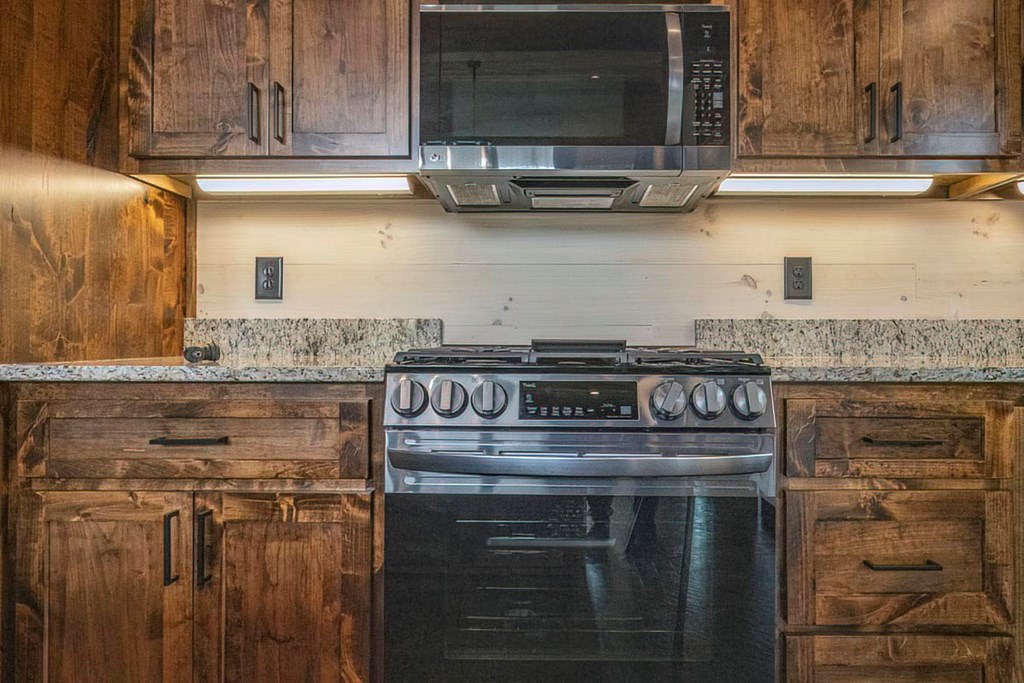 506 Pony Ghost Trail Blue Ridge, GA 30513 - Photo 58 of 62 a kitchen with stainless steel appliances granite countertop a stove and a microwave