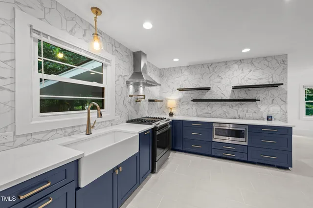 a kitchen with stainless steel appliances granite countertop a sink and wooden cabinets