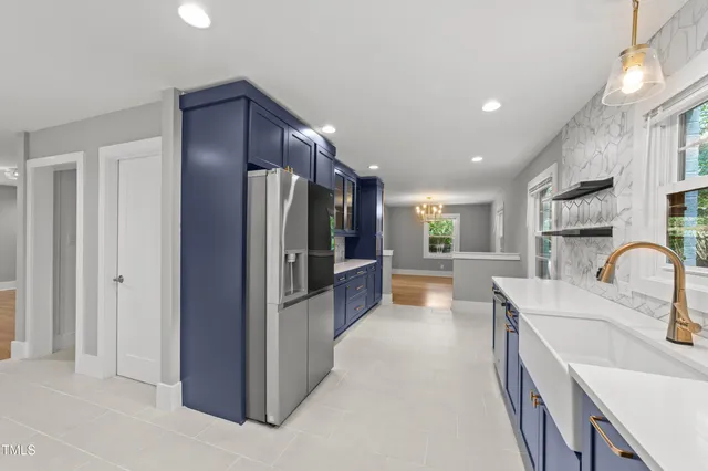 a kitchen with refrigerator and cabinets