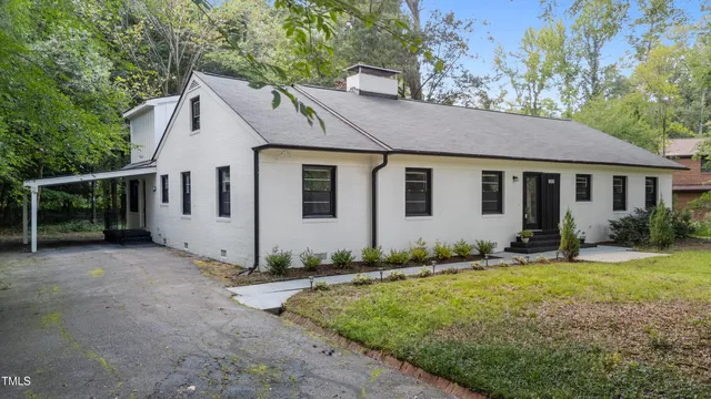 a view of a white house with a yard
