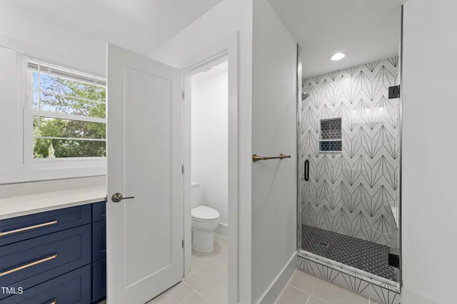 a bathroom with a shower and toilet