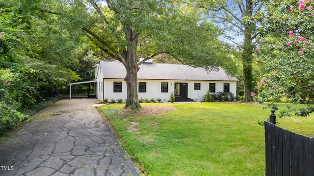 a front view of a house with yard and green space