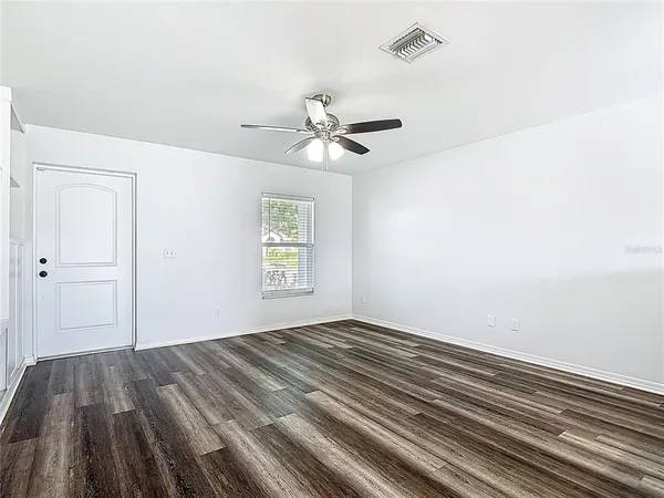 wooden floor in an empty room with a window