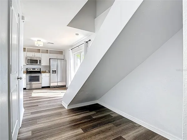 a view of staircase with white walls and window
