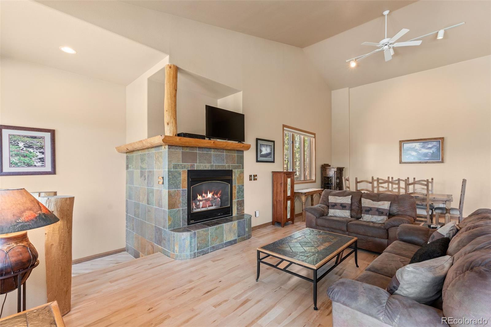 92 Emmett Lode Road, Unit B Breckenridge, CO 80424 - Photo 11 of 50 a living room with furniture a flat screen tv and a fireplace
