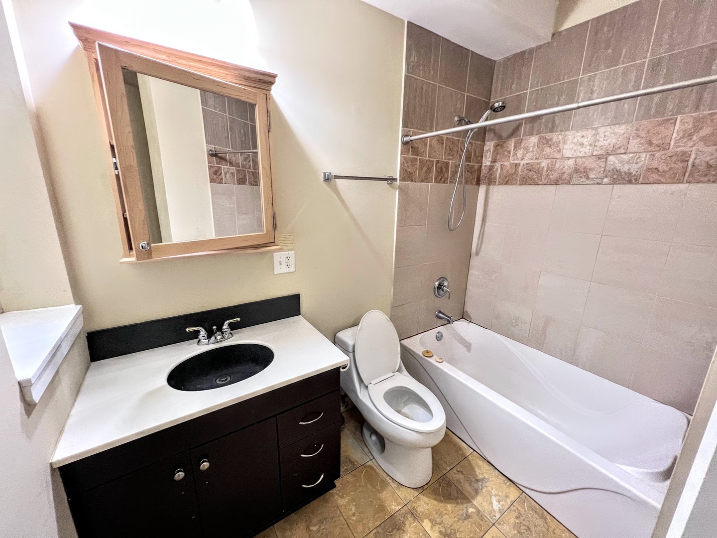 3605 West Leland Avenue, Unit 1E Chicago, IL 60625 - Photo 11 of 14 a bathroom with a sink a toilet and shower