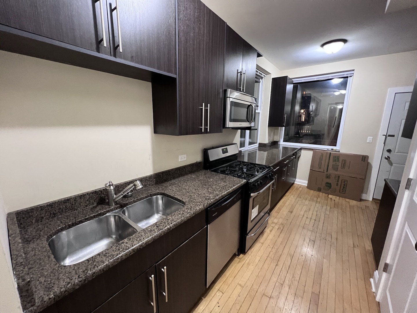 3605 West Leland Avenue, Unit 1E Chicago, IL 60625 - Photo 6 of 14 a kitchen with a sink and a stove top oven