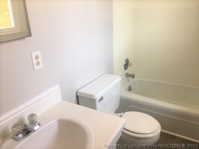 434 Saddle Ridge Road Fayetteville, NC 28311 - Photo 10 of 16 a white toilet sitting next to a bath tub and a shower