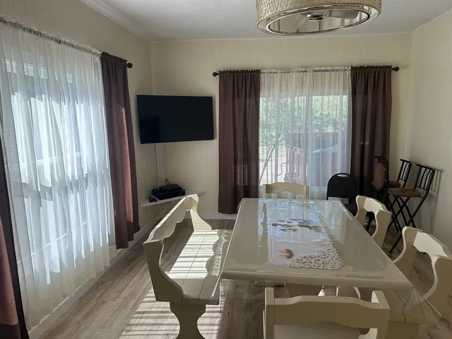 a view of a dining room with furniture window and outside view