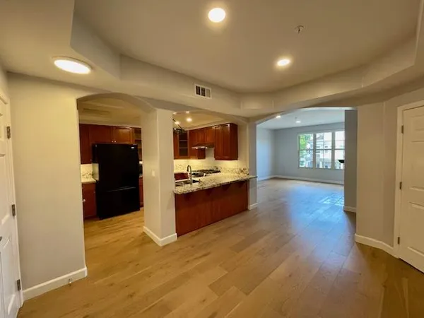 a large kitchen with a large counter top appliances and cabinets