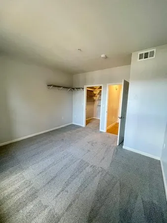 an empty room with closet and wooden floor