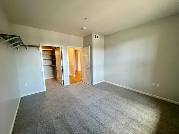 a view of walk in closet with empty racks