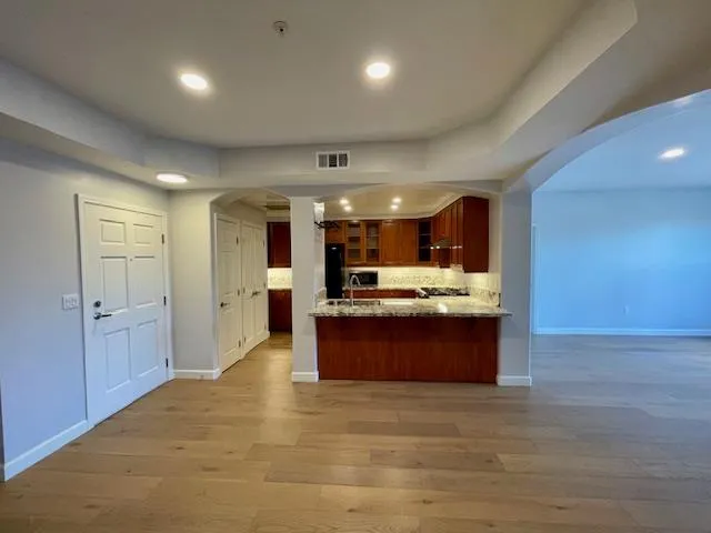 a large room with a large window and stainless steel appliances