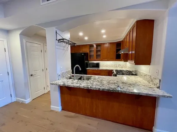 a bathroom with a granite countertop sink a large mirror and shower