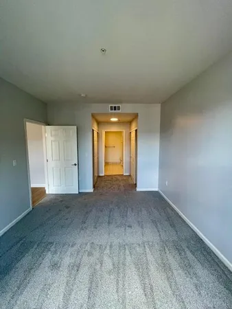 an empty room with a empty space and windows