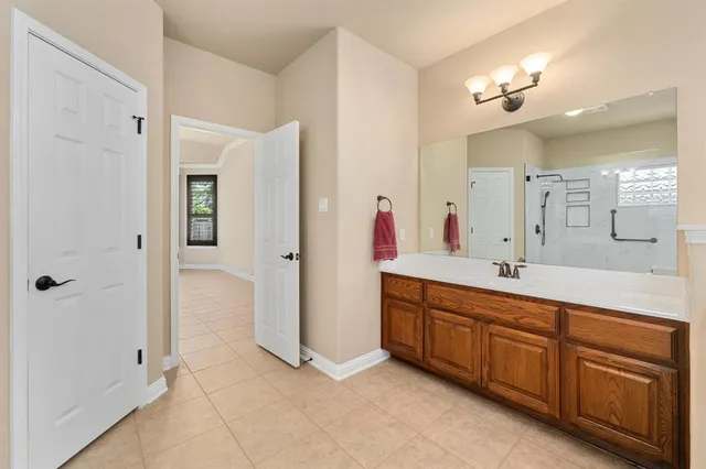 a bathroom with a glass shower door