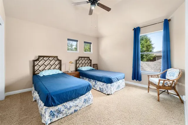 a bedroom with a bed and a ceiling fan