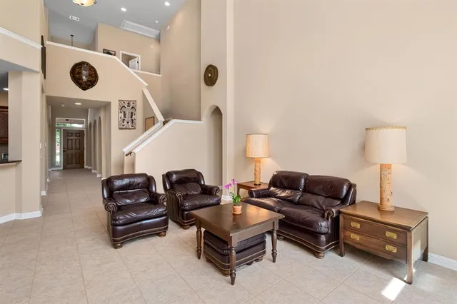 a living room with furniture and kitchen view