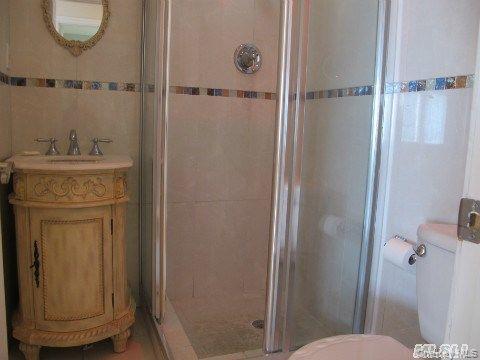 5 Elm Street Great Neck, NY 11021 - Photo 13 of 17 a bathroom with a granite countertop sink toilet and shower