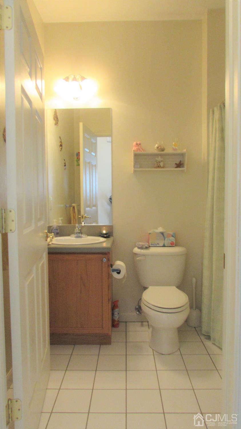 91 Wordsworth Road Brick, NJ 08724 - Photo 11 of 41 a bathroom with a toilet sink and mirror
