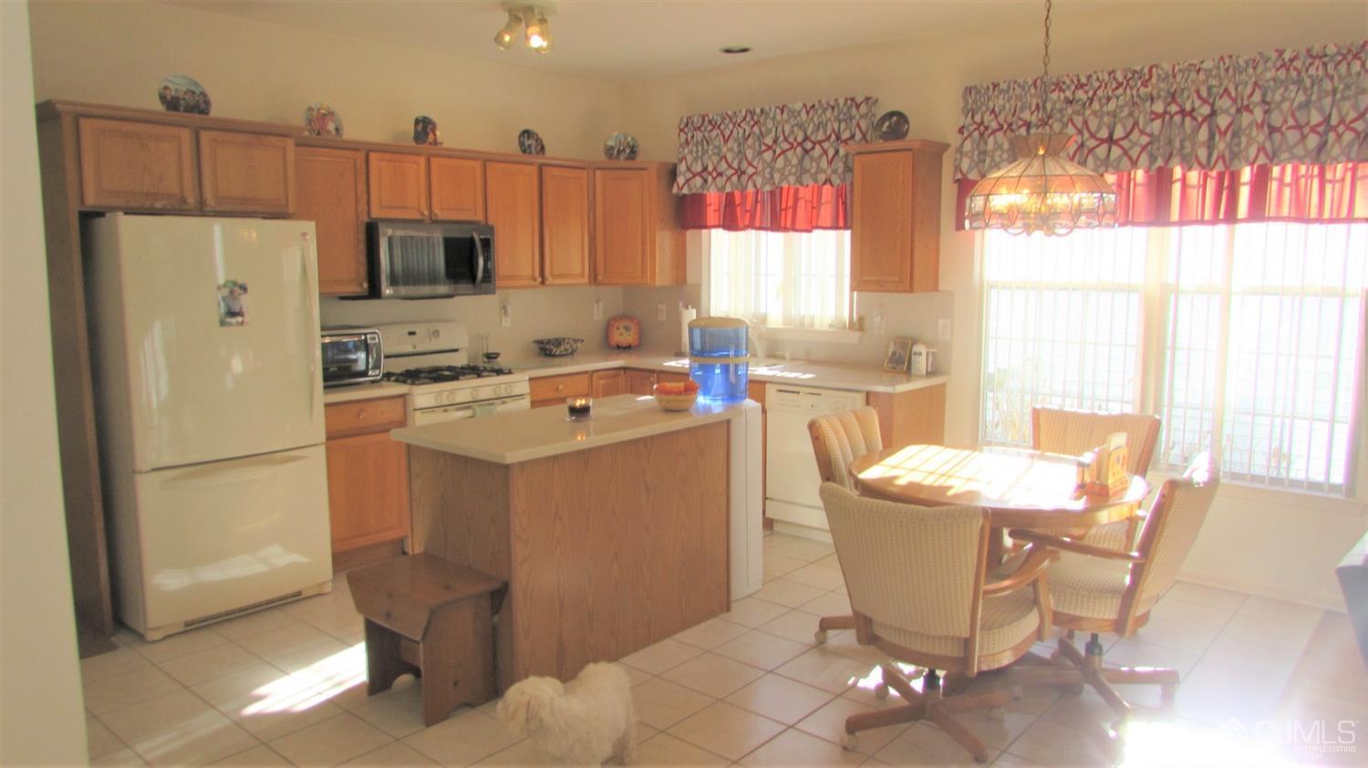 91 Wordsworth Road Brick, NJ 08724 - Photo 21 of 41 a kitchen with a sink a stove a refrigerator cabinets and dining table