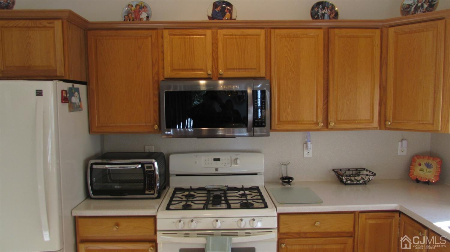 91 Wordsworth Road Brick, NJ 08724 - Photo 22 of 41 a kitchen with stainless steel appliances a stove a microwave and a refrigerator
